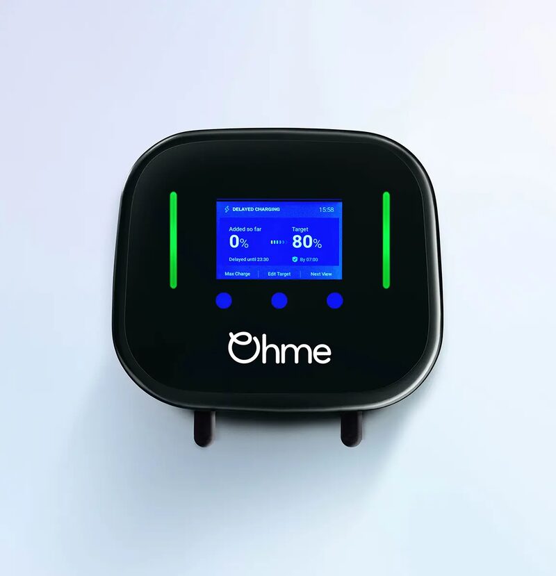 A black Ohme Home Pro wall-mounted EV charger with a blue display screen showing delayed charging settings and green indicator lights
