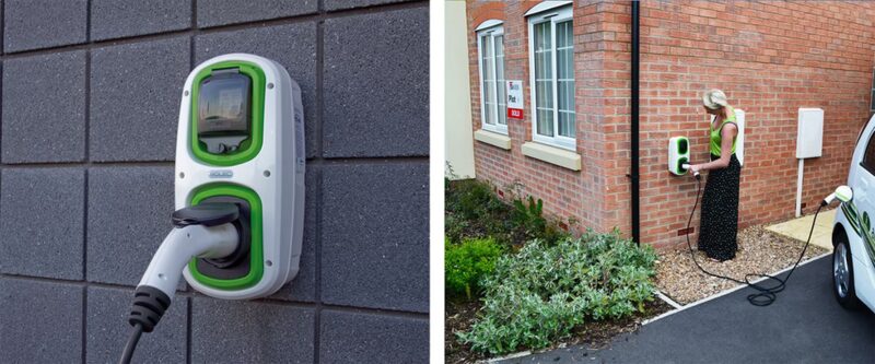 A wall-mounted green and white Rolec EV chargepoint with a plugged-in cable, alongside a woman charging an electric car outside a brick house
