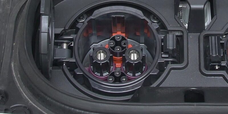Close-up of a CHAdeMO charging socket on an electric car's charge port