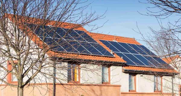 Solar panels installed on the tiled roof of a residential house
