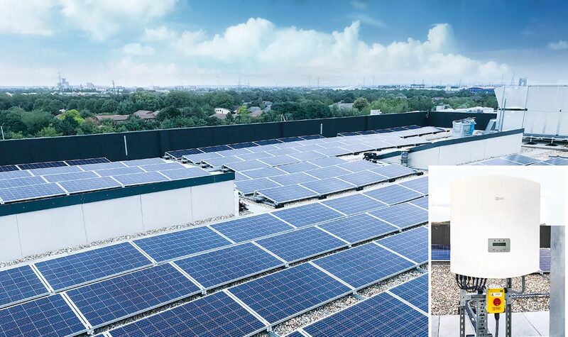 A large rooftop solar panel installation with an inset photo of a wall-mounted solar inverter