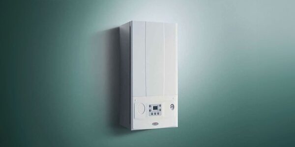 A white wall-mounted combi gas boiler with a control panel, photographed against a plain green background