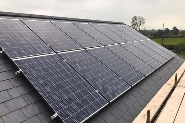 Solar panels mounted on a slate roof using a pitched-roof mounting system
