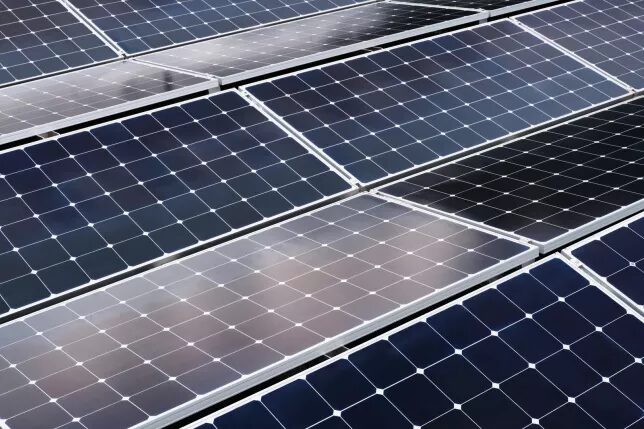 Rows of solar panels arranged at an angle, seen from above