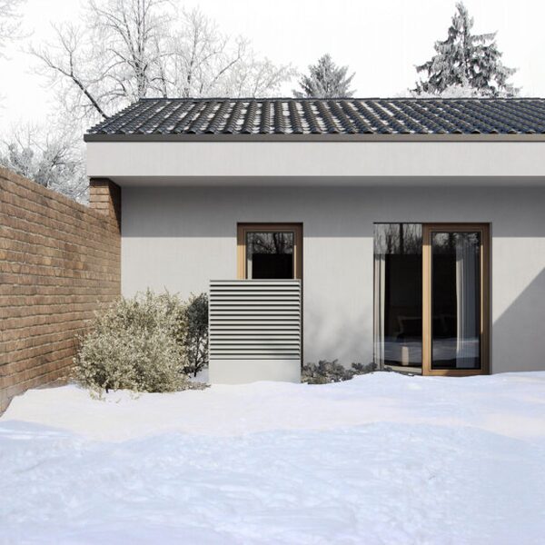 An air-to-water heat pump unit installed outside a modern house in a snowy garden