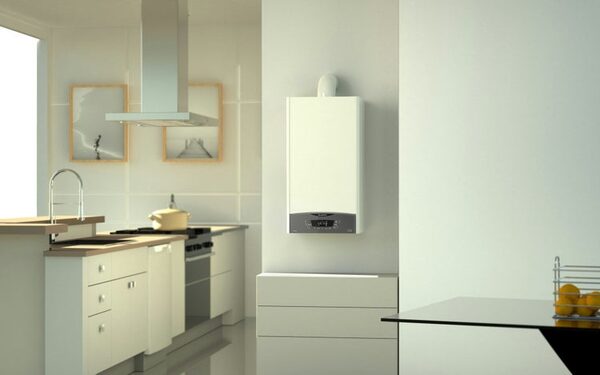 A white wall-mounted gas boiler installed in a modern kitchen