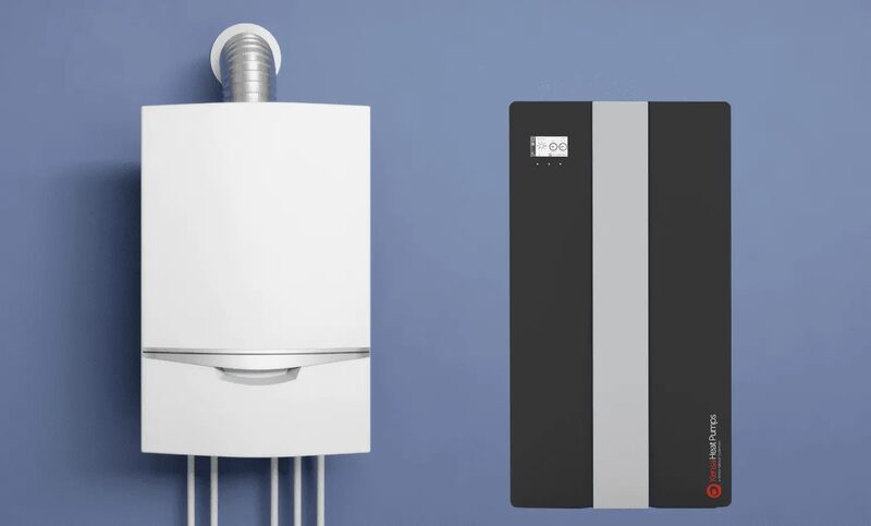 A white wall-mounted gas boiler next to a dark grey Kensa heat pump unit against a blue wall