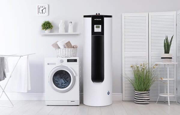 A Hitachi hot water cylinder heat pump installed in a utility room next to a washing machine
