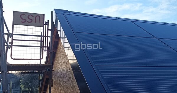 GB Sol in-roof solar panels being installed on a house roof next to scaffolding