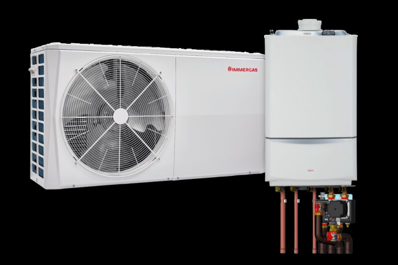 An Immergas air source heat pump outdoor unit shown beside a wall-mounted hybrid boiler unit with exposed pipework and valves