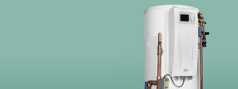 A white Ideal Heating heat pump cylinder hot water tank with copper pipework and a control display against a plain teal background