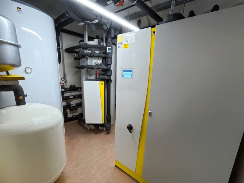 An iDM heat pump system with buffer and hot water cylinders installed in a plant room
