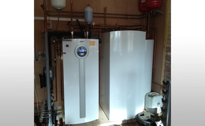 An IVT ground source heat pump unit and hot water cylinder installed in a plant room with copper pipework