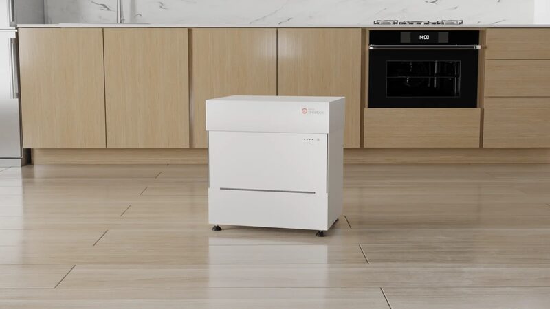 A white Kensa Shoebox ground source heat pump unit standing in a modern kitchen