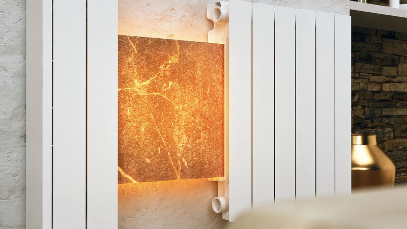 A white Rointe electric radiator mounted on a wall with a glowing natural stone panel visible behind it