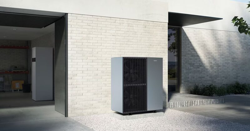 A Viessmann Vitocal 151-A monobloc air source heat pump unit installed outside a modern white brick house