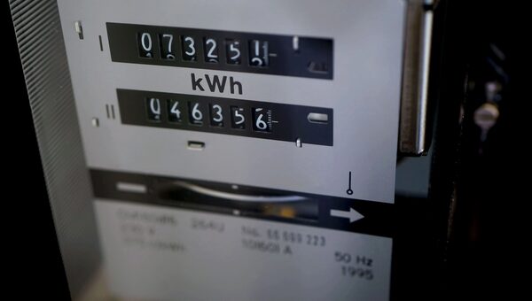 A close-up of an old mechanical electricity meter with two kWh dial counters