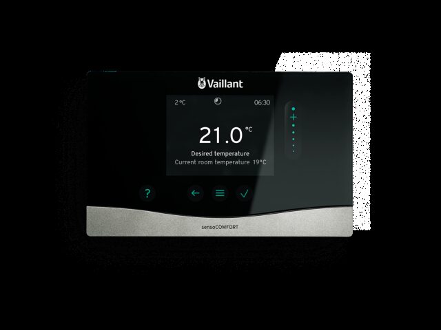 A Vaillant sensoCOMFORT wall-mounted heating control thermostat with a black touchscreen showing room temperature