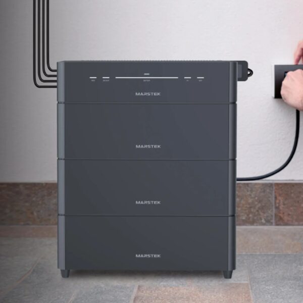 A stacked Marstek Venus D home battery unit plugged into a wall socket indoors