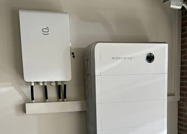 A Sigenergy home battery unit and wall-mounted inverter installed on an interior wall