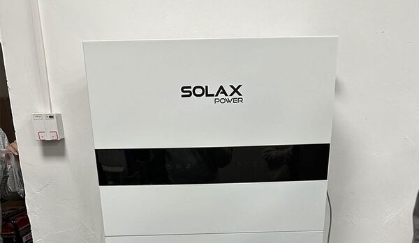 A white SolaX Power home battery storage unit mounted on a wall