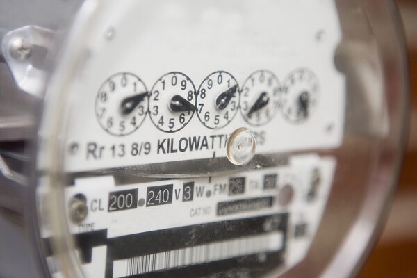 A close-up of a traditional analogue electricity meter with kilowatt-hour dial readout
