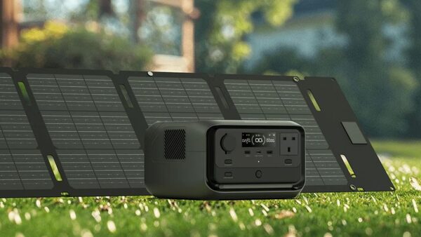 An EcoFlow RIVER 3 Plus portable power station with a folding solar panel set up on a lawn