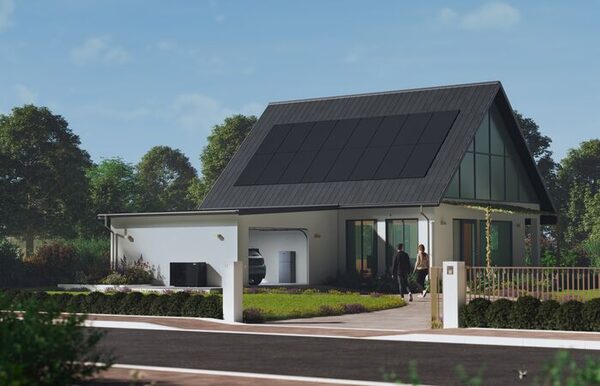 A modern house with solar panels on the roof and a battery unit in the garage, with two people walking up the driveway