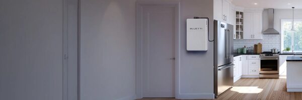 A white BLUETTI home battery unit mounted on a wall in a modern kitchen