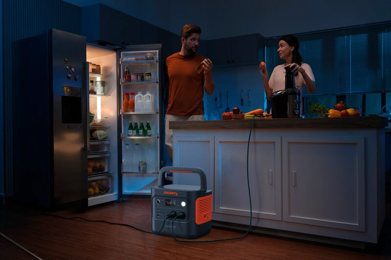 A Jackery Explorer 2000 v2 portable power station on a kitchen worktop with UK plug sockets and a small display