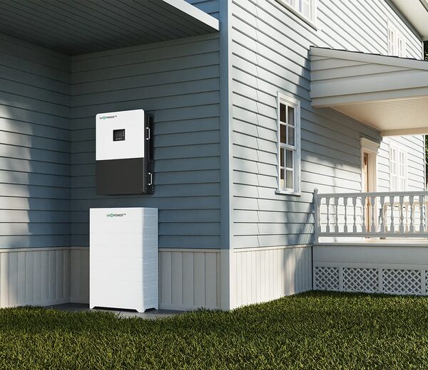 A Luxpower hybrid inverter and battery unit installed on the exterior wall of a house