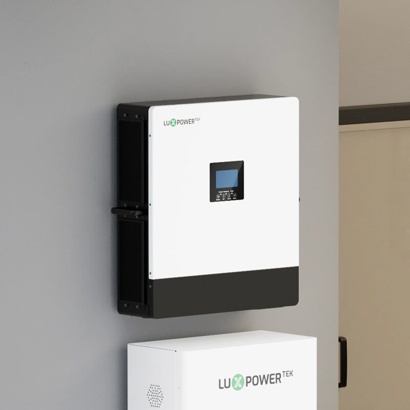 A white LuxpowerTek wall-mounted off-grid solar inverter with display screen installed on a grey wall above a matching LuxpowerTek battery unit