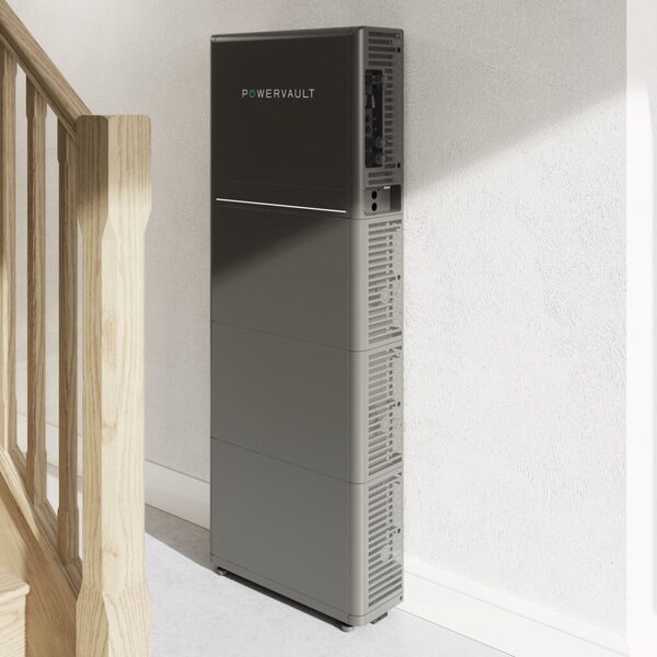 A tall grey Powervault P5 home battery storage unit standing against a wall next to a wooden staircase