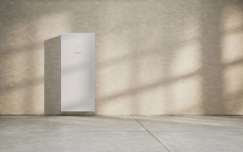 A white sonnen home battery mounted on a plain wall in a minimalist room
