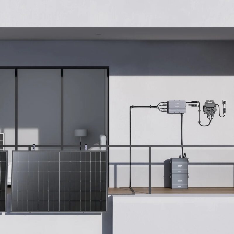 A Zendure SolarFlow balcony solar setup with panels leaning on a balcony rail, a wall-mounted hub unit and a stacked battery on the balcony floor