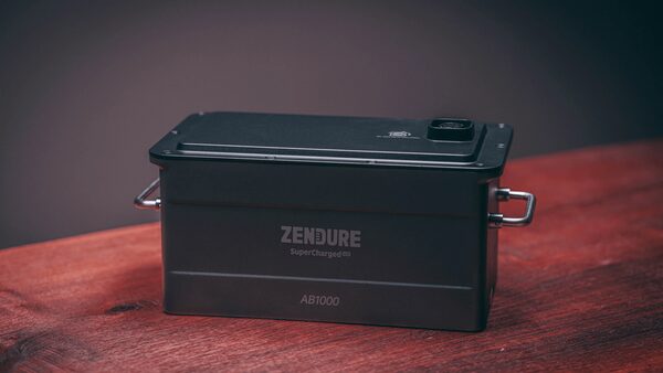A black Zendure AB1000 SolarFlow battery unit sitting on a wooden table
