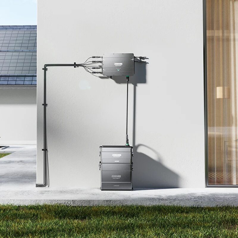 A Zendure SolarFlow battery stack and hub unit installed on an exterior house wall next to solar panels
