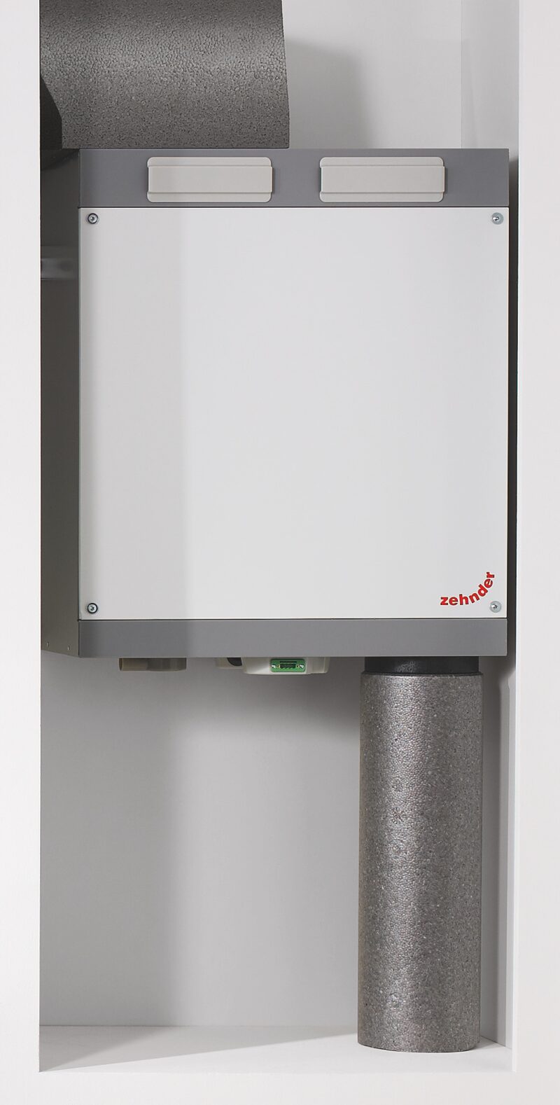 A Zehnder ComfoAir 180 mechanical ventilation unit with insulated ducting installed in a cupboard