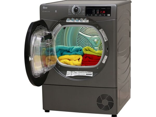 A grey Hoover heat pump tumble dryer with its door open, showing colourful towels inside the drum