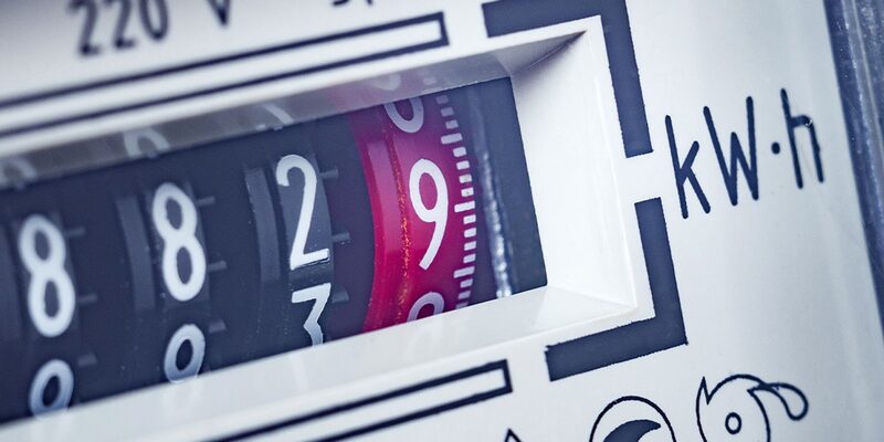 A close-up of an electricity meter's mechanical digit dials showing kilowatt-hour readings