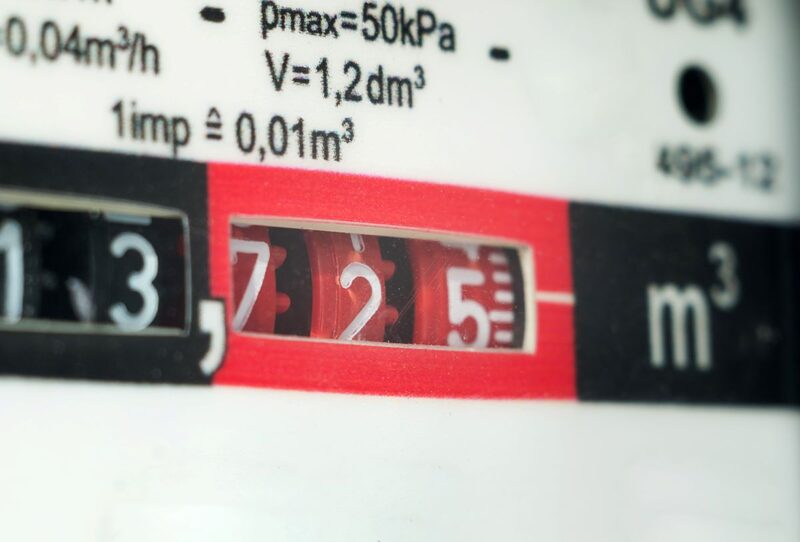 Close-up of a gas meter dial register showing cubic metre readings and technical specifications