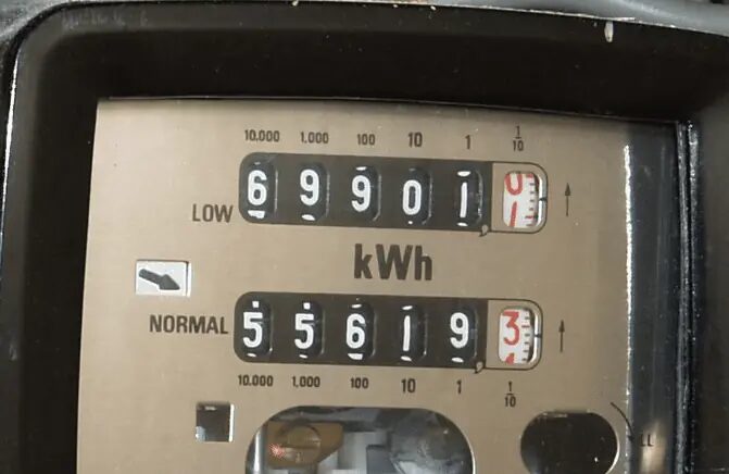 Close-up of a two-rate electricity meter with LOW and NORMAL digital dial registers reading in kWh
