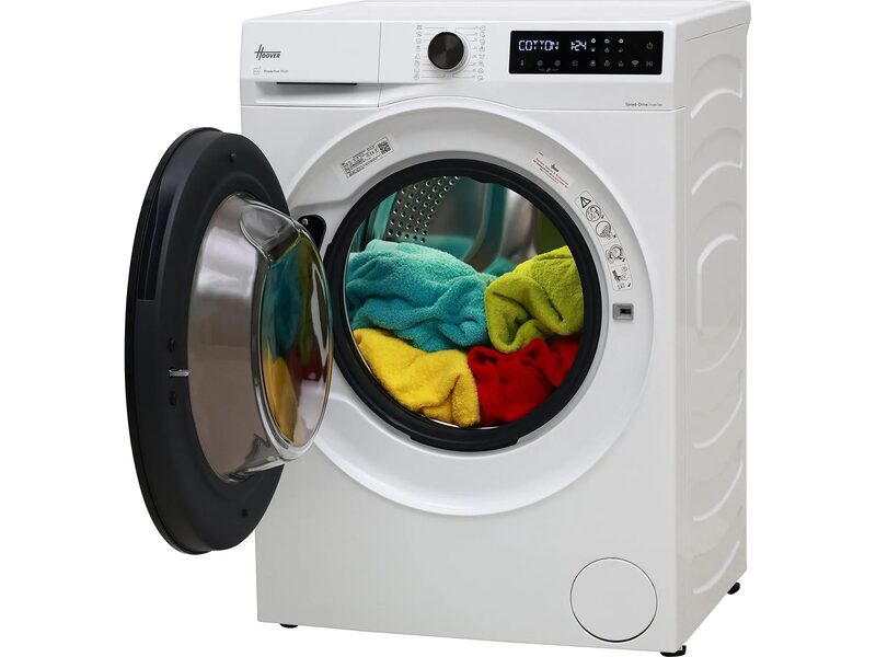 A white Hoover front-loading washing machine with the door open and colourful towels inside the drum