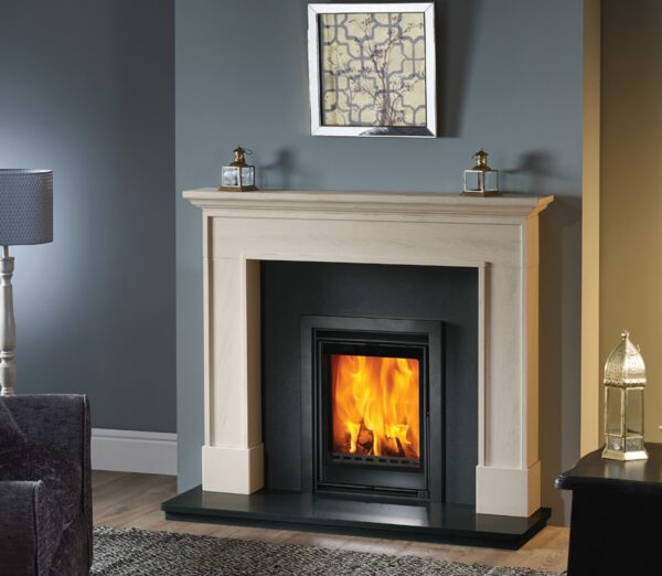 An inset wood-burning stove with flames visible, installed in a cream stone fireplace surround in a living room