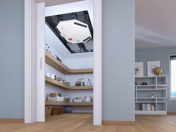 A Zehnder ComfoAir Flex mechanical ventilation unit mounted in the ceiling above a pantry cupboard in a home