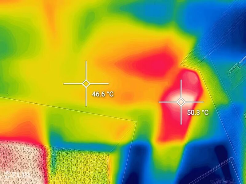 A thermal imaging camera view of a house exterior showing heat loss, with temperature readings of 46.6°C and 50.3°C marked on warm areas