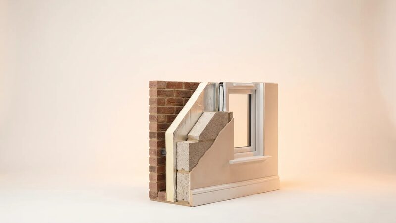 A cutaway model of a cavity wall with insulation and a window, showing wall construction layers