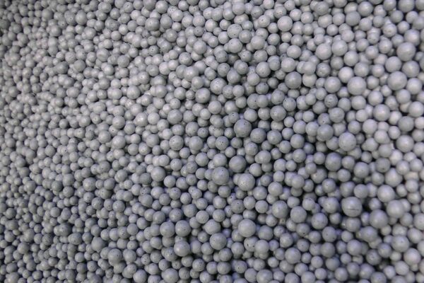 A close-up of grey polystyrene insulation beads used for cavity wall insulation