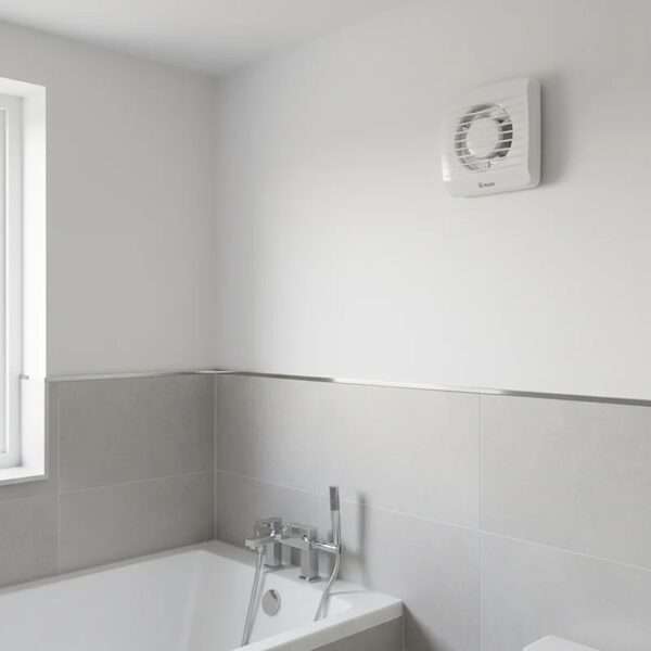 A white Xpelair axial extractor fan mounted on a white bathroom wall above a tiled wall and bathtub