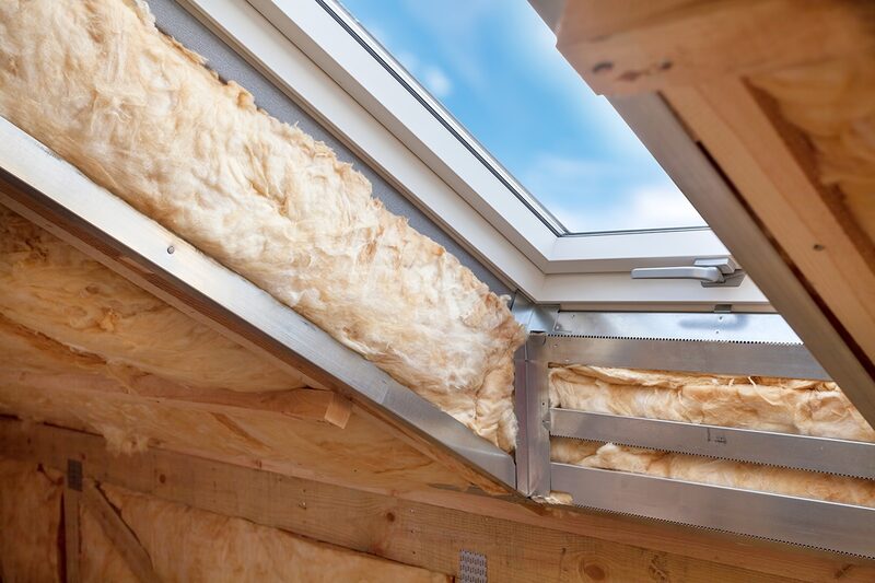 Mineral wool loft insulation fitted around a roof window in a loft conversion